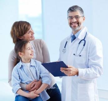 A doctor in an office using a laptop who has a medical IT services package