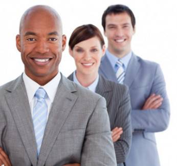 Two men and a woman all in suits standing and smiling because they know they have professional it services